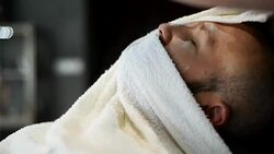 Close-up of beautiful attractive adult man with beard in a barber shop Stock Footage