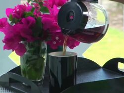 Blond girl on a terrace, pouring some coffe Stock Footage