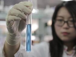 A female scientist checking a test tube Stock Footage