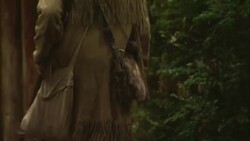 A fur trapper enters through a log gate. Stock Footage