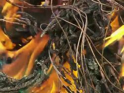 ECU Shot of burning plastic from electric cables to recover copper and others scavenging scrap metal / Lagos, Nigeria Stock Footage