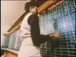 A woman rings a bell on a table. News Clip