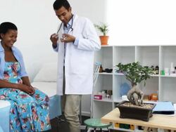 Doctor talks through pills with patient Stock Footage