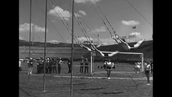 Female gymnasts perform on rings and do rhythmic gymnastics routine on field in Italian arena News Clip