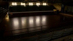 An athlete dribbles down an empty court and shoots a jump shot. Stock Footage