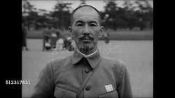 1939: EMPEROR OF JAPAN: WS Japanese soldiers walking by army post. MS Officer taking off hat bowing. WS Emperor of Japan Hirohito (1901-1989) on horseback w/ aides. WS Japanese soldiers bowing. MS Hirohito riding horse. Instructional Video