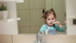 Pretty toddler girl brushing her teeth Stock Footage