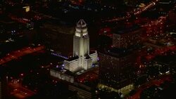 Aerial shot orbiting around the Los Angeles City Hall in Los Angeles, California, at night Stock Footage
