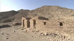 A circular pattern of rocks fronts crumbling ruins in the hills of Shenshef, Egypt. Stock Footage