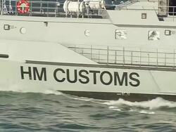 MS AERIAL ZO Shot of customs petrol craft name / Suffolk, France Stock Footage