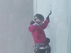 MS ZI ZO Ice climber continues to climb on pillar using hooks and background in foggy and snow on falling / Stanley Headwall Valley,British Columbia,Canada Stock Footage