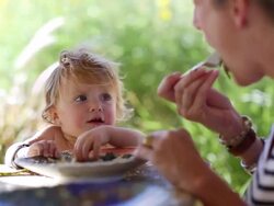 MS Shot of baby boy and his mother eating outside / Santa Fe, New Mexico, United States  Stock Footage