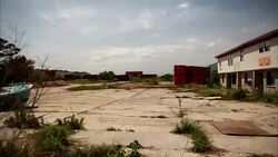 Clouds race over a littered lot of an apartment building near storage units. Stock Footage