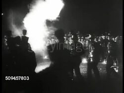 1936: U.S. PRESIDENTIAL CAMPAIGN: LA WS 'Landon-Knox' sign, poster on building. MS Woman hanging Franklin Roosevelt poster. LA MS Banner 'National Democratic Club.' NIGHT: Torchlight parade. HA WS Marching band & paraders. WS Fireworks. Election Instructional Video