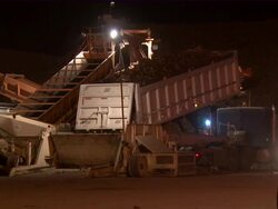CU of truck emptying its sugar beets into the conveyor belt, which transfers the beets to a very large pile. Stock Footage