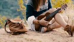 Hippie girl playing ukulele Stock Footage