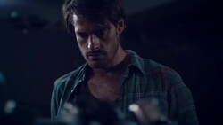 Man in motorcycle workshop looking at his bike Stock Footage