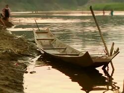 MS SLO MO Shot of canoe moored on river bank in sunset light / Luang Prabang, Laos Stock Footage