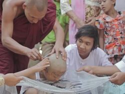 MS Shot of monk shaving a boy's head / Bagan, Mandalay Division, Myanmar Stock Footage