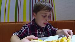 Boy eating a pizza Stock Footage
