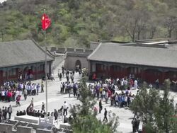 WS View of Great Wall courtyard with red Chinese flag / Beijing, China Stock Footage