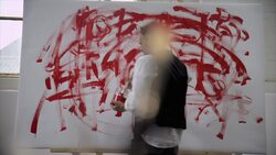 Artist painting with red color on canvas Stock Footage