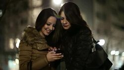 Girls in the city texting on smartphone Stock Footage