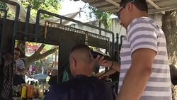 CLEAN : Favela residents watch Olympic boxing at makeshift barbershop News Clip