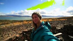 Young woman on mountain top taking selfie portrait Stock Footage