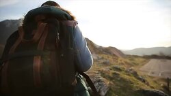 Traveler with backpack walking in mountains Stock Footage