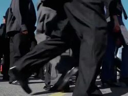 Low angle medium shot crowd of businesspeople walking back and forth Stock Footage