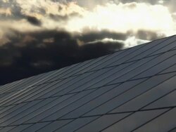 HD Solar Park Against Moody Sky TL (4:2:2@100 Mb/s) Stock Footage