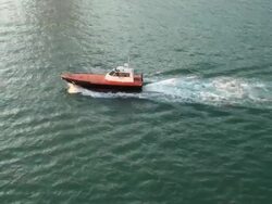 Generic pilot boat joining the ship to help entering harbor Stock Footage
