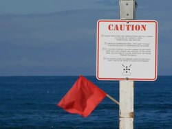 Beach warning sign dangerous ocean waters Stock Footage