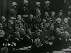 1945: NUREMBERG TRIALS: VS Nazi Germans stand in docket, Joachim von Ribbentrop holding papers, unidentified soldier, Wilhelm Frick, Julius Streicher at microphone, Franz von Papen, Wilhelm Keitel, Konstantin von Neurath. War Crimes, military tribunal Instructional Video