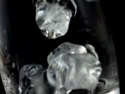HD Super Slow-Mo: Ice Cubes Falling Into A Glass Stock Footage