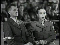 1945: MILITARY TRIBUNAL: FIRST WITNESS: MS Joseph Pusch & interpreter translating (German-English) Pusch's eyewitness account of crime, Pusch standing up to demonstrate. Testimony, U.S. war trial. Instructional Video