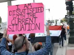 Marchers with signs and Syrian flag against war. Stock Footage