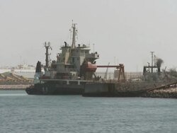 MS POV Boat of harbor and tall tug boats moored side on beach / Doha, Qatar Stock Footage
