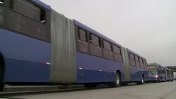 Biofuel buses leave a bus depot. Stock Footage