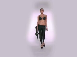 WS SLO MO Shot of Caucasian female walking to camera holding MR27 machine gun and about to load it / Studio, New York, United States Stock Footage