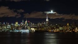 Manhattan, Moonrise over the  Empire State Building and Midtown Manhattan looking across the Hudson River, New York, United States of America - Time lapse Stock Footage