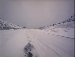 WA Cars driving carefully along snowy freeway, North Carolina, USA Stock Footage