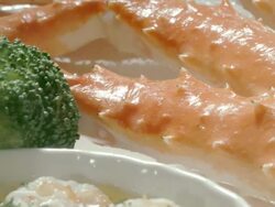 ECU TS across sea food dishes with king crab legs and shrimp cooked in butter sauce under layer of parmesan cheese  Stock Footage