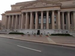 Dolly shot of the National Archives Building at the North side of Pennsylvania Ave. with lens flare Stock Footage