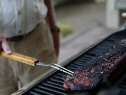 CU TU Shot of senior man cooking ribs on outdoor grill / Lamy, New Mexico, United States Stock Footage