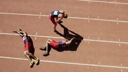 Exhausted male runners laying on track Stock Footage