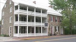 The historic Fairfield Inn in Gettysburg, Pennsylvania,  features a stone facade and two levels of white balconies. Stock Footage