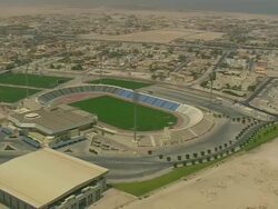 WS AERIAL DS ZI ZO View of sports stadiums in city / Qatar Stock Footage