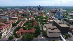 Aerial Over University of Texas Campus UT Clock Tower Austin Texas Skyline Panning to the Side Stock Footage